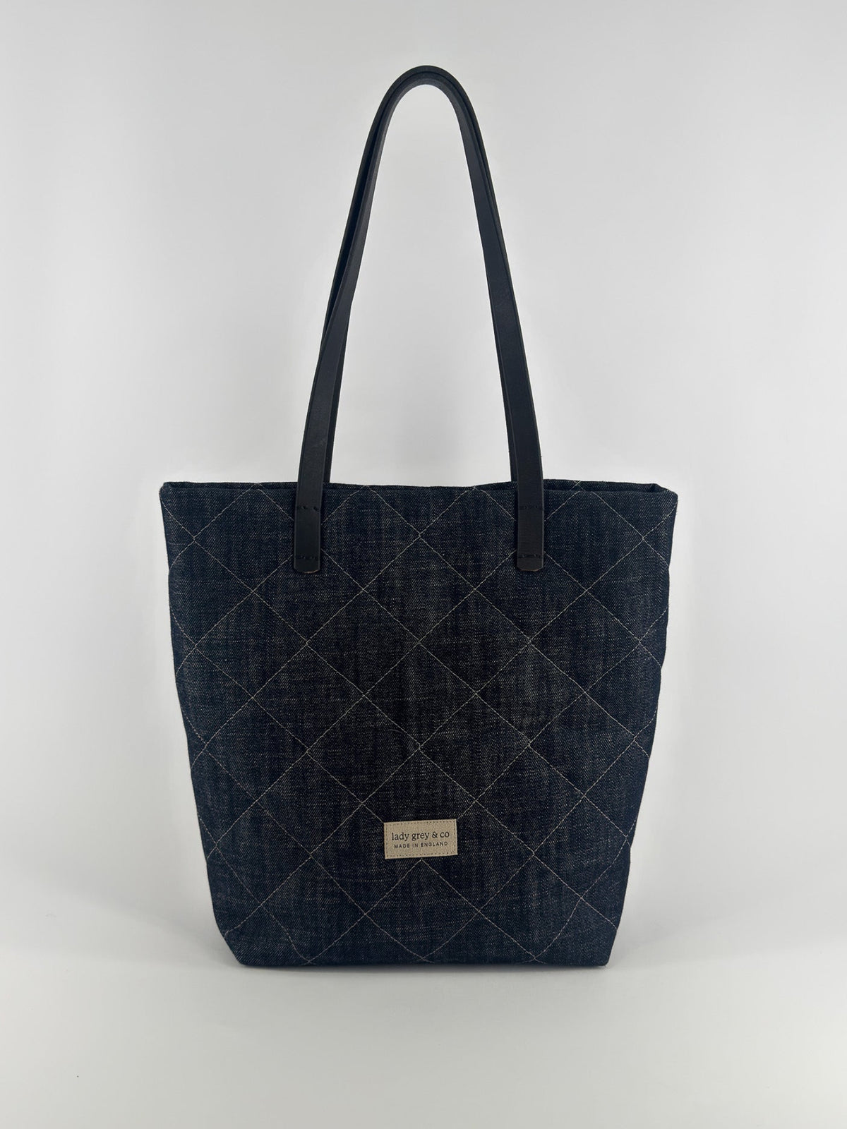 Quilted denim tote bag on a white background