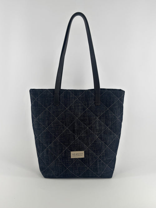 Quilted denim tote bag on a white background