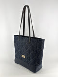 Denim tote bag with black handles on a white background